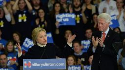 Democratic presidential candidate Hillary Clinton speaks as husband, former President Bill Clinton looks on at Southern New Hampshire University February 9, 2016 in Hooksett, New Hampshire.