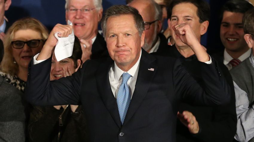 Republican presidential candidate Ohio Governor John Kasich arrives on stage at a campaign gathering with supporters upon placing second place in the New Hampshire republican primary on February 9, 2016 in Concord, New Hampshire.
