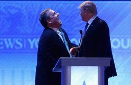 Chris Christie and Donald Trump share a laugh during a commercial break in the Republican presidential debate February 6, 2016, in Manchester, New Hampshire.