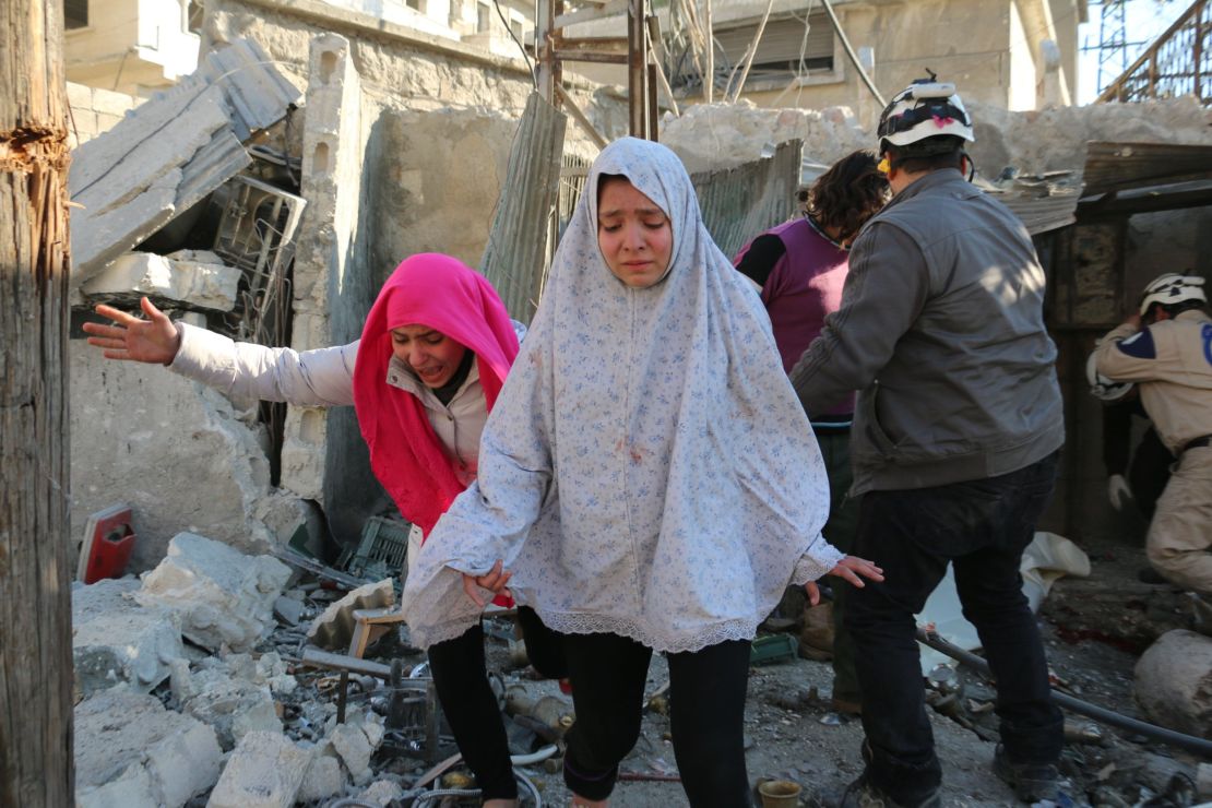 Syrian girls react following a reported Syrian regime air strike in a rebel-controlled area in the northern city of Aleppo in February.