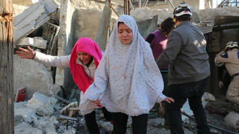 Syrian girls react following a reported Syrian regime air strike in a rebel-controlled area in the northern city of Aleppo in February.