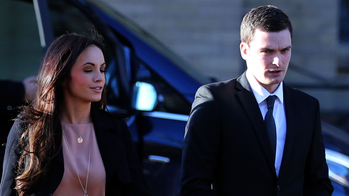 Adam Johnson arrives with ex-girlfriend Stacey Flounders at the Crown Court in Bradford, England.