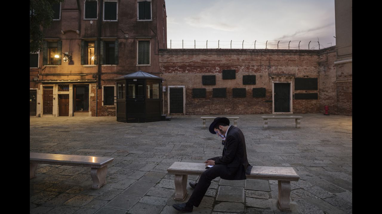 A Jewish scholar reads in an empty courtyard in Italy's Venetian Ghetto. Jews were forced to live for centuries in this part of Venice, and it is where the modern-day word of "ghetto" was derived.