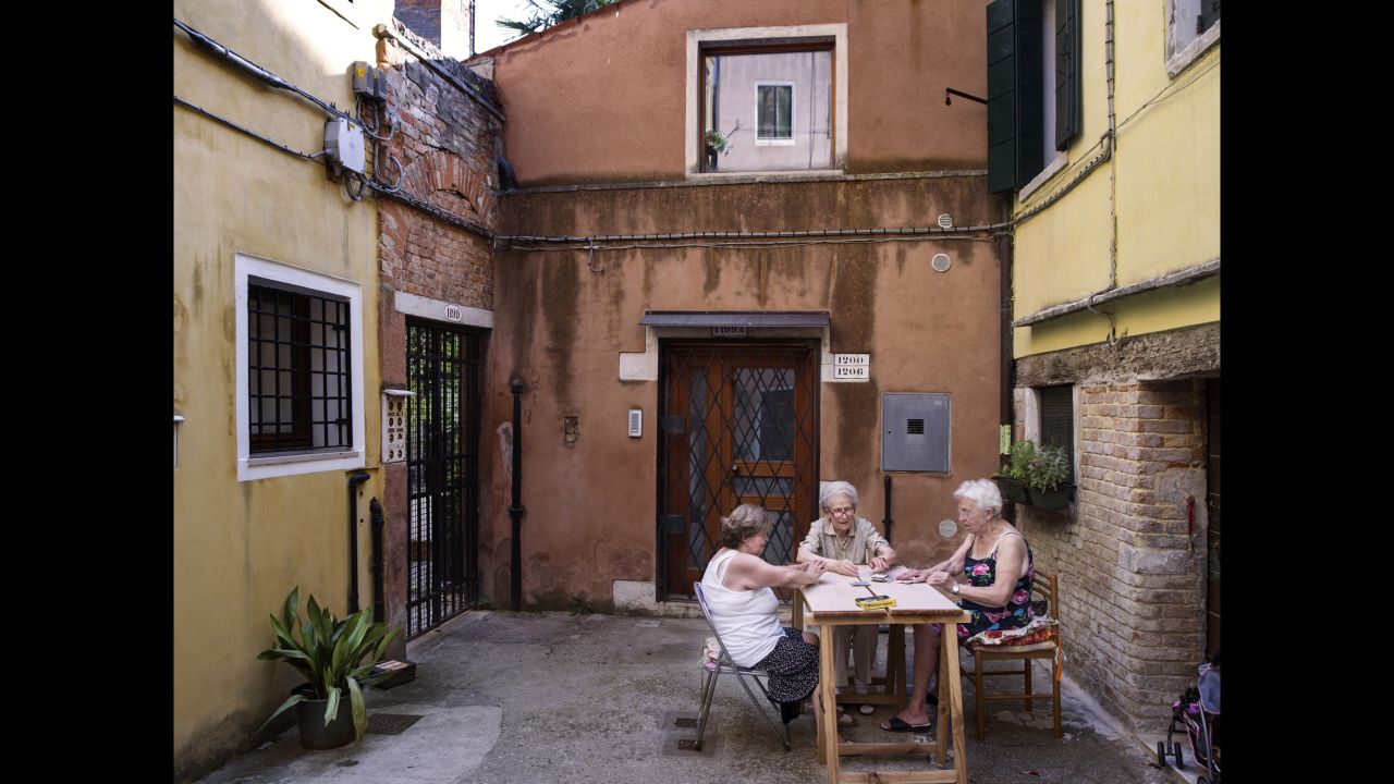 Ghetto residents play cards in a courtyard.