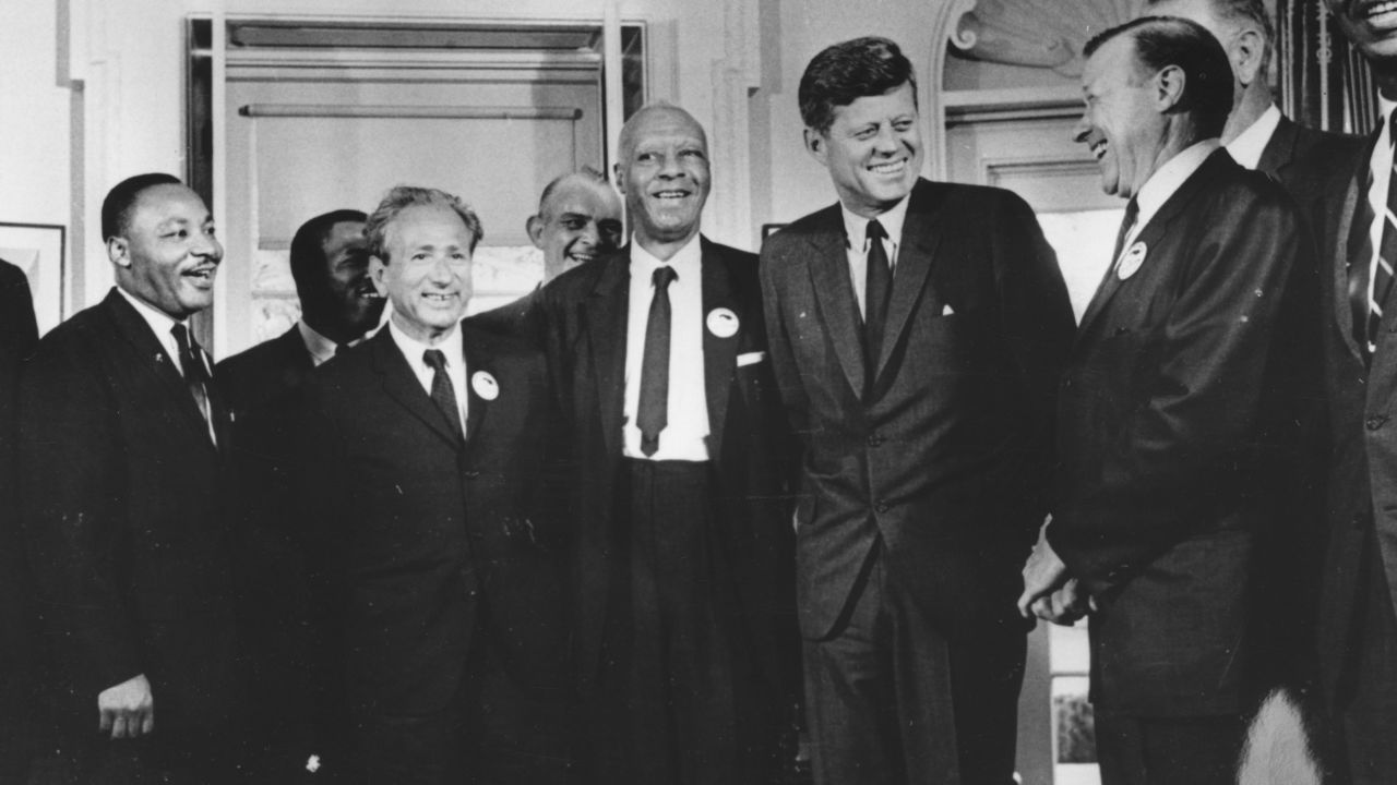 Kennedy deemed civil rights a "moral issue" in June 1963, stating that America "will not be fully free until all its citizens are free." Here, he stands with civil rights leaders who organized the 1963 March on Washington, including Martin Luther King Jr. on the far left.