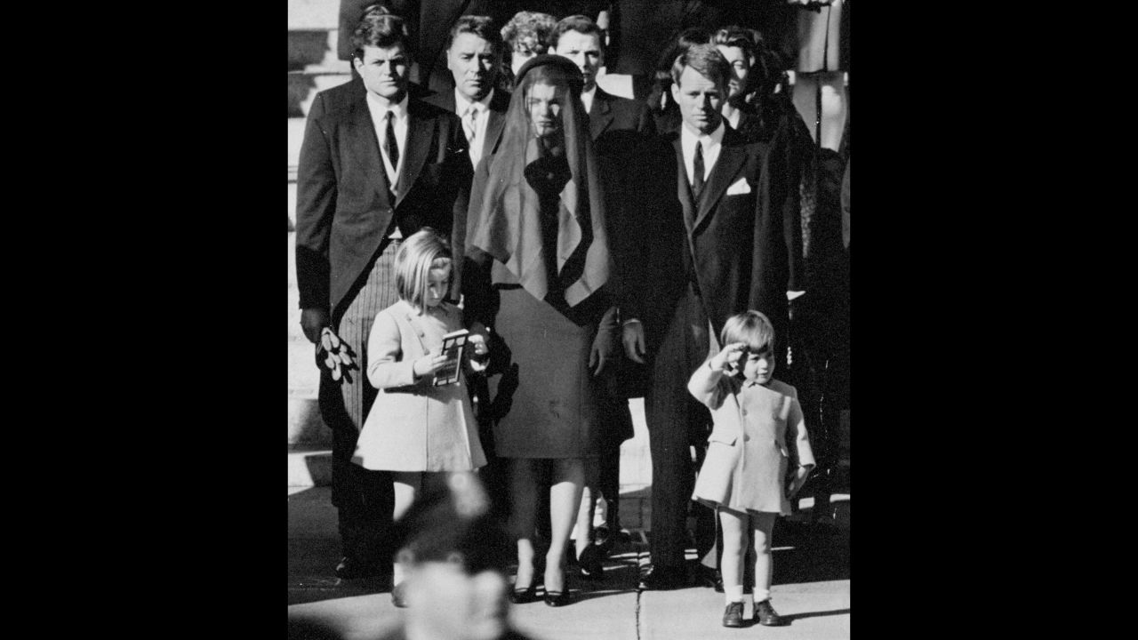 John F. Kennedy Jr., age 3, salutes his father's flag-draped casket in this iconic image taken at the President's funeral procession in Washington.