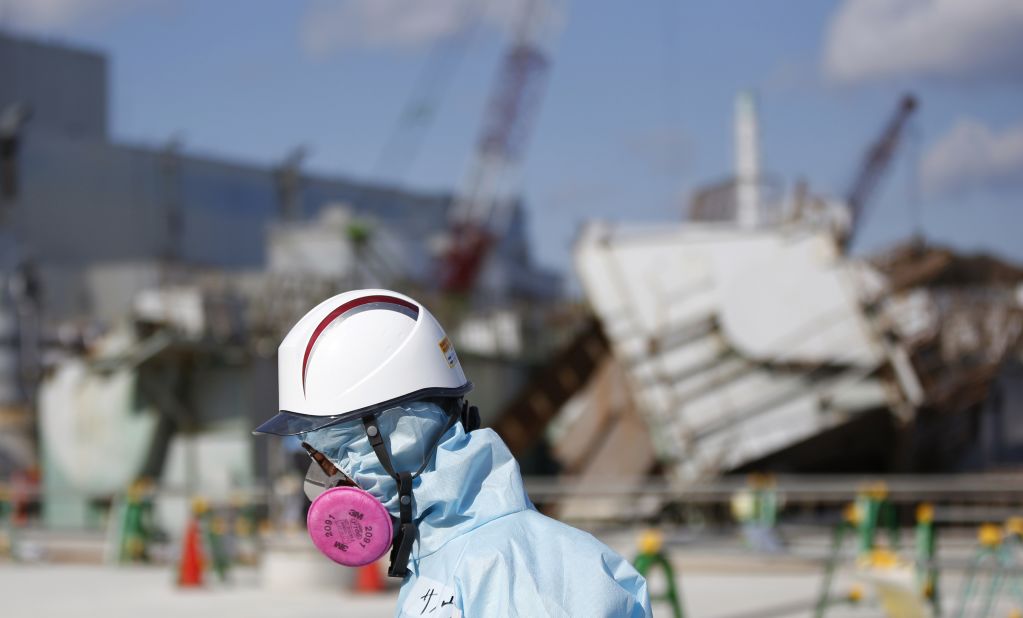 A TEPCO employee walks past the No. 1 reactor at the Fukushima Daiichi nuclear plant on February 10, 2016. Next month, Japan will mark the fifth anniversary of the Fukushima disaster, when an earthquake and tsunami hit on March 11, 2011, leaving more than 15,000 people dead.