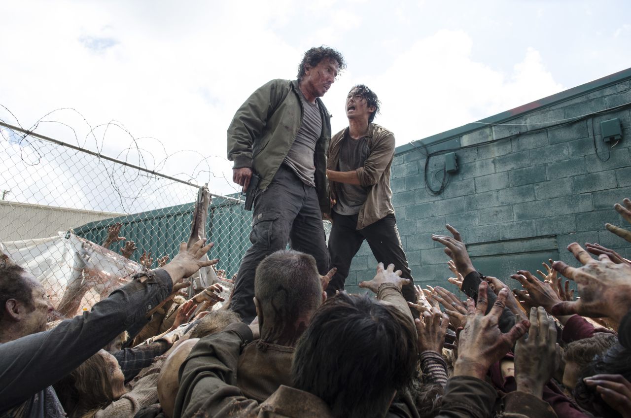 Fans were almost starting to warm up to Nicholas (Michael Traynor, left) by the time a gang of walkers devoured him in front of Glenn (Steven Yeun). Glenn managed to avoid the same fate by hiding under a garbage bin.