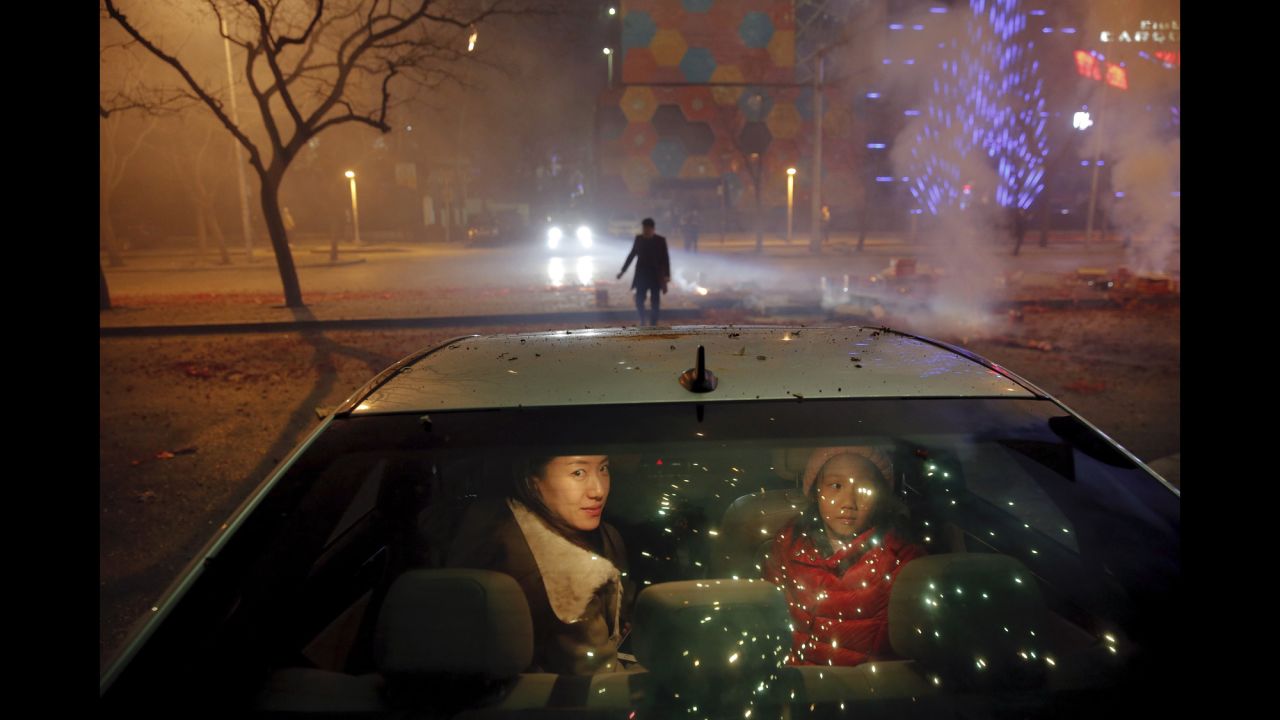 People watch fireworks during <a href="http://www.cnn.com/2016/01/31/world/gallery/year-of-the-monkey-lunar-new-year/index.html" target="_blank">Lunar New Year celebrations</a> in Beijing on Sunday, February 7.