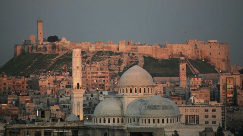 A picture taken 17 March 2006 shows a general view of the historic Syrian city of Aleppo, 350 kms north of Damascus, with its landmark cytadel in the background. Hundreds of Arab and foreign personalities will gather in Aleppo this weekend to celebrate its choice as the Arab world's capital of Islamic culture for 2006. Syrian Culture Minister Riad Nassan Agha said yesterday Aleppo was chosen by the Organization of the Islamic Conference (OIC) because of its role as the "main point of passage between East and West." Two days of inaugural festivities will kick off 18 March 2006 with the rededication of the 12th-century Great Mosque (C), which has been under restoration for the past five years. AFP PHOTO/RAMZI HAUDAR (Photo credit should read RAMZI HAIDAR/AFP/Getty Images)