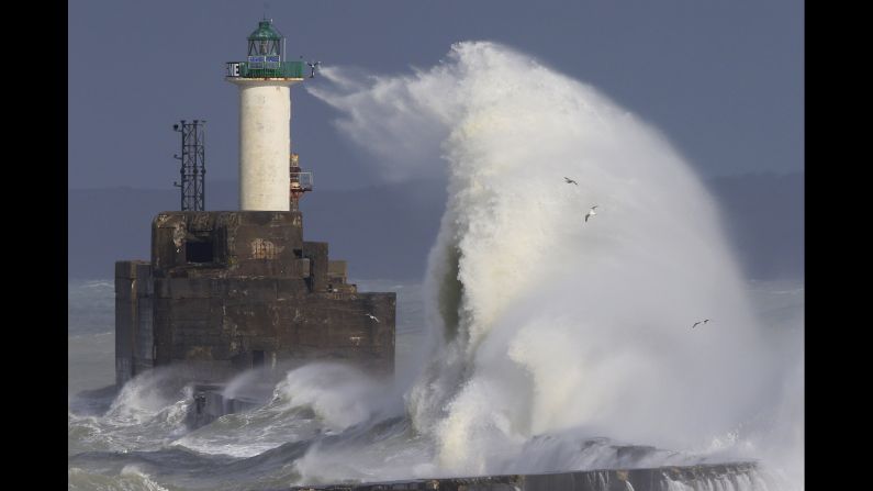 Waves crash against a lighthouse during heavy winds in Boulogne-sur-Mer, France, on Sunday, February 7.