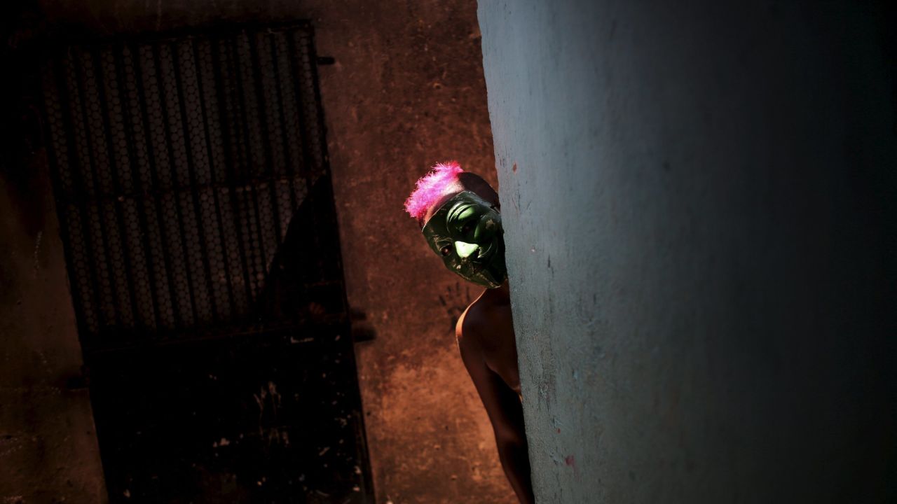 A masked boy peeks around a corner during a <a href="http://www.cnn.com/2016/02/05/world/gallery/carnival-2016/index.html" target="_blank">Carnival</a> party in Recife, Brazil, on Sunday, February 7.