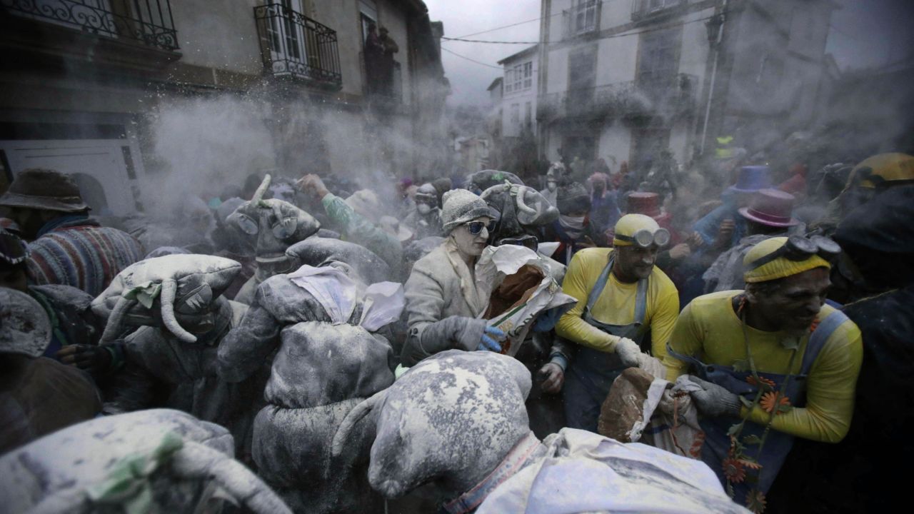 Revelers participate in a flour fight during "O Entroido," a weeklong festival in Laza, Spain, on Monday, February 8.