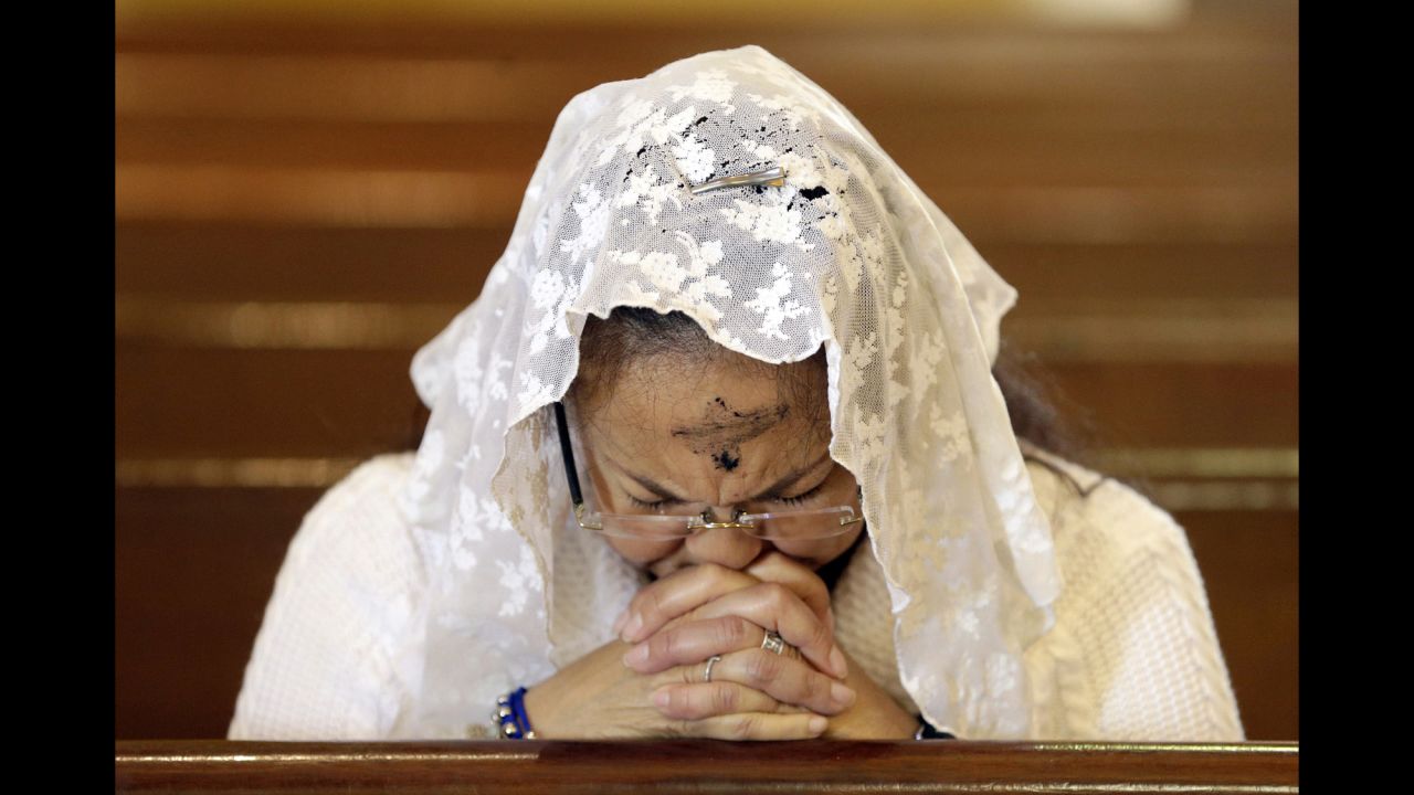 A woman prays at a Miami church on Ash Wednesday, February 10.
