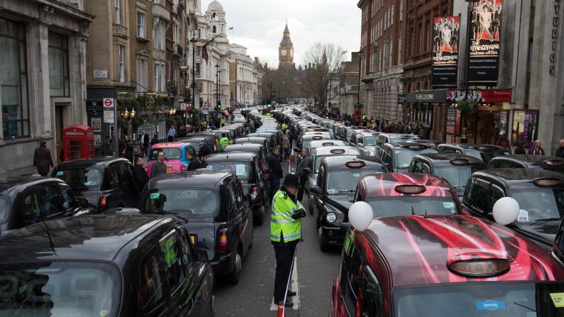Cab drivers block a street in London as they protest the Uber car service on Wednesday, February 10.