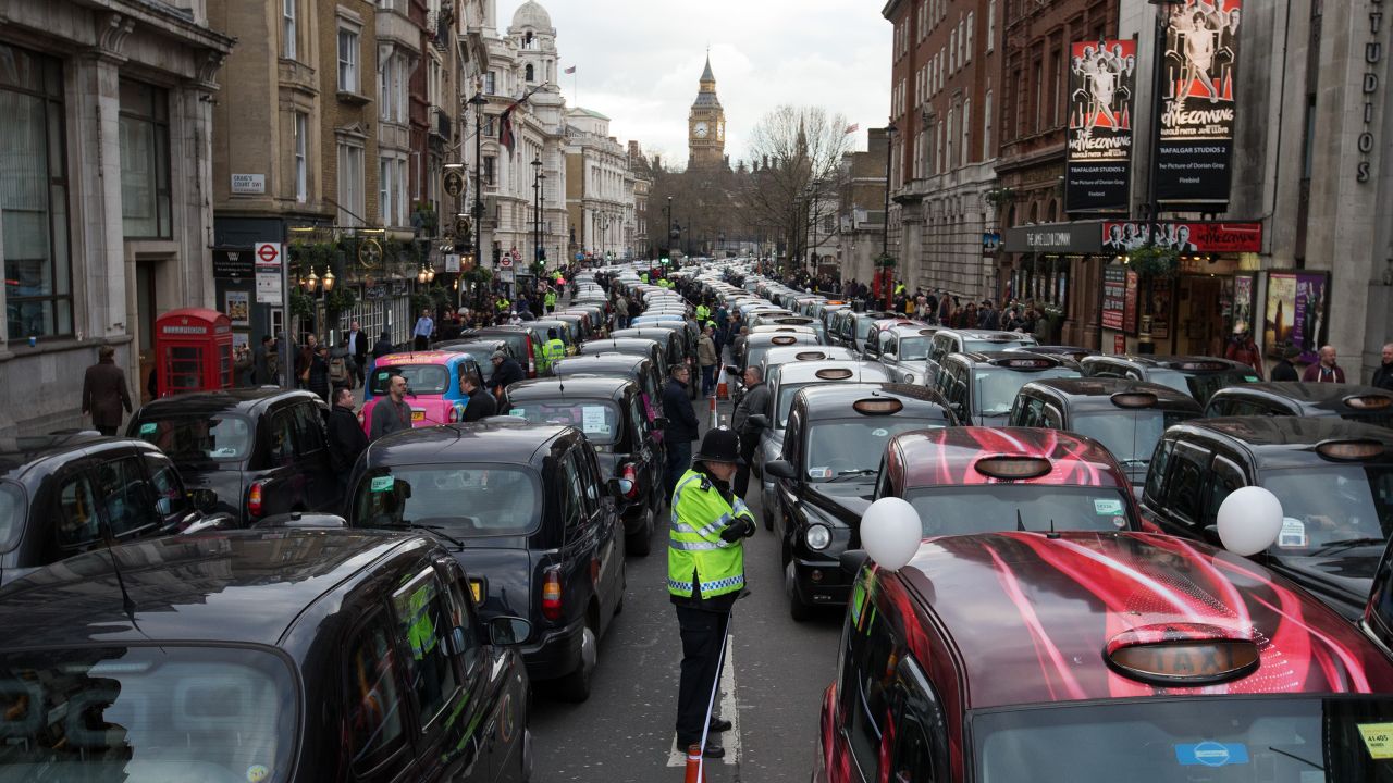 Cab drivers block a street in London as they protest the Uber car service on Wednesday, February 10.