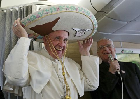 Pope Francis tries on a traditional sombrero he received as a gift from a Mexican journalist on Friday, February 12, 2016, aboard a flight from Rome to Havana, Cuba. The voyage kicked off his weeklong trip to Mexico. With his penchant for crowd-pleasing and spontaneous acts of compassion, Pope Francis has earned high praise from fellow Catholics and others since he succeeded Pope Benedict XVI in March 2013.