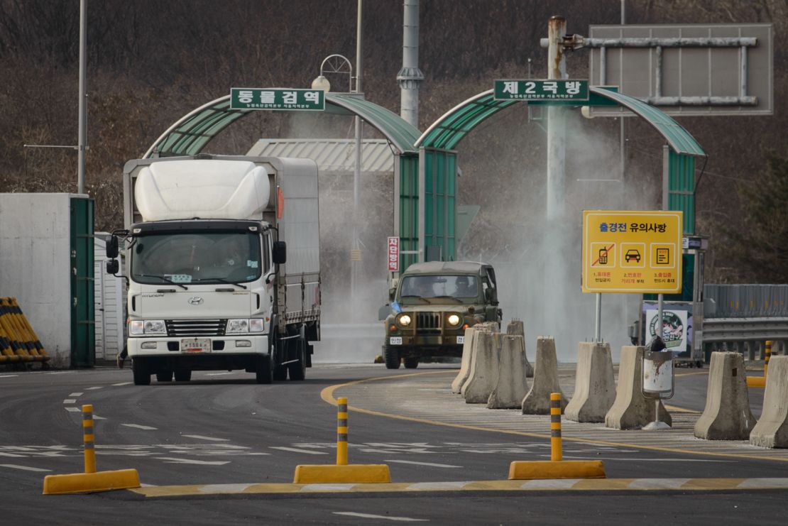 A vehicle leaving the Kaesong joint industrial zone passes through disinfectant spray before a checkpoint at the CIQ immigration centre near the Demilitarized Zone (DMZ) separating North an South Korea, in Paju on February 11, 2016. 