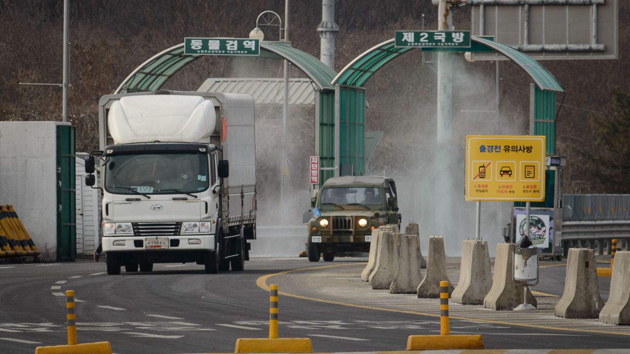 A vehicle leaving the Kaesong joint industrial zone passes through disinfectant spray before a checkpoint at the CIQ immigration centre near the Demilitarized Zone (DMZ) separating North an South Korea, in Paju on February 11, 2016.