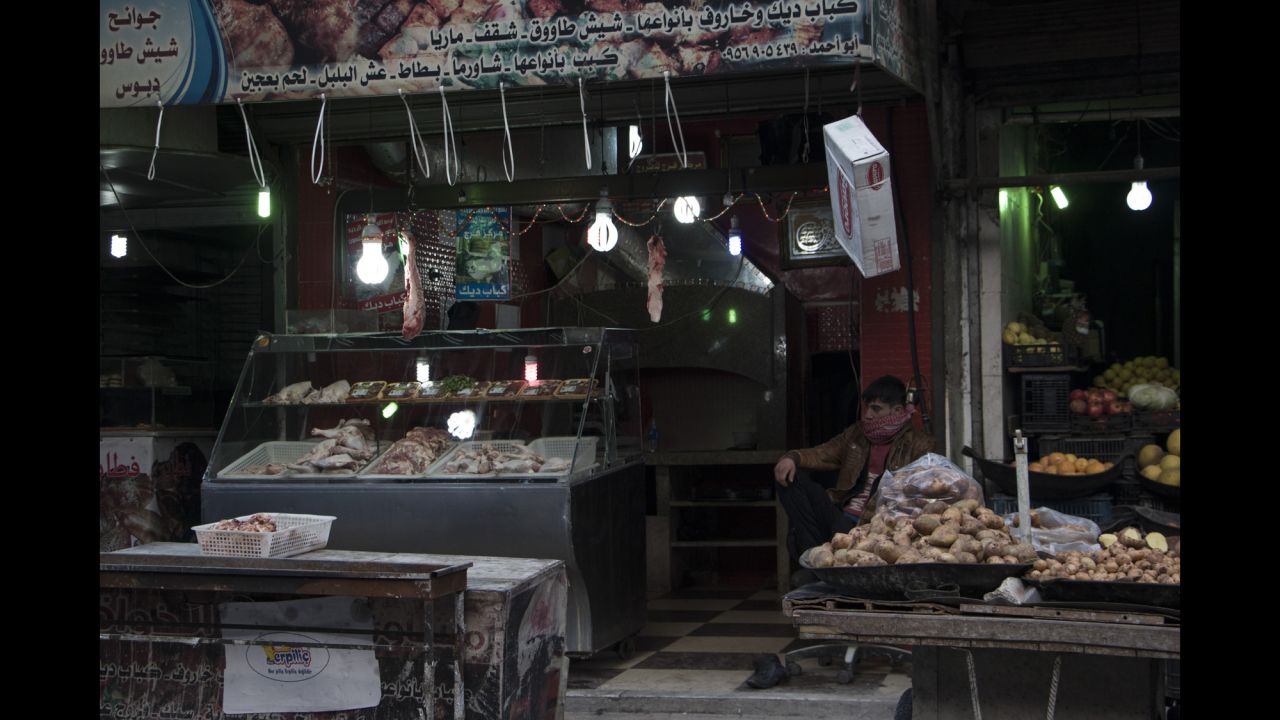 A stall holder waits for customers; there are reports of some hoarding of rice and flour as the regime's siege tightens.