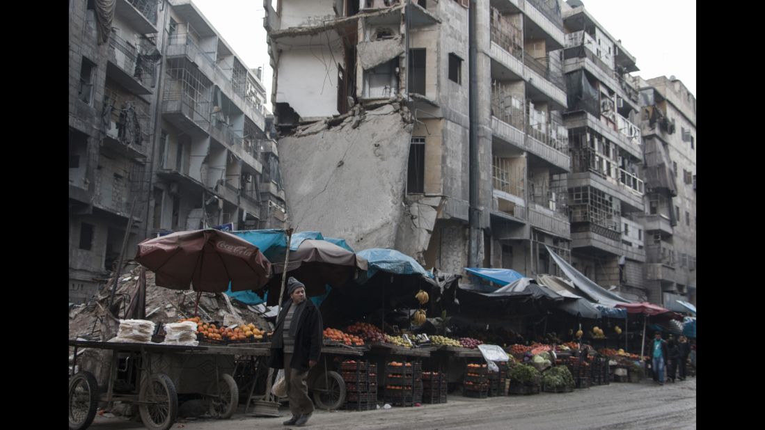 A street market in Aleppo that is still open despite constant airstrikes -- and the huge slab of concrete hanging over it.