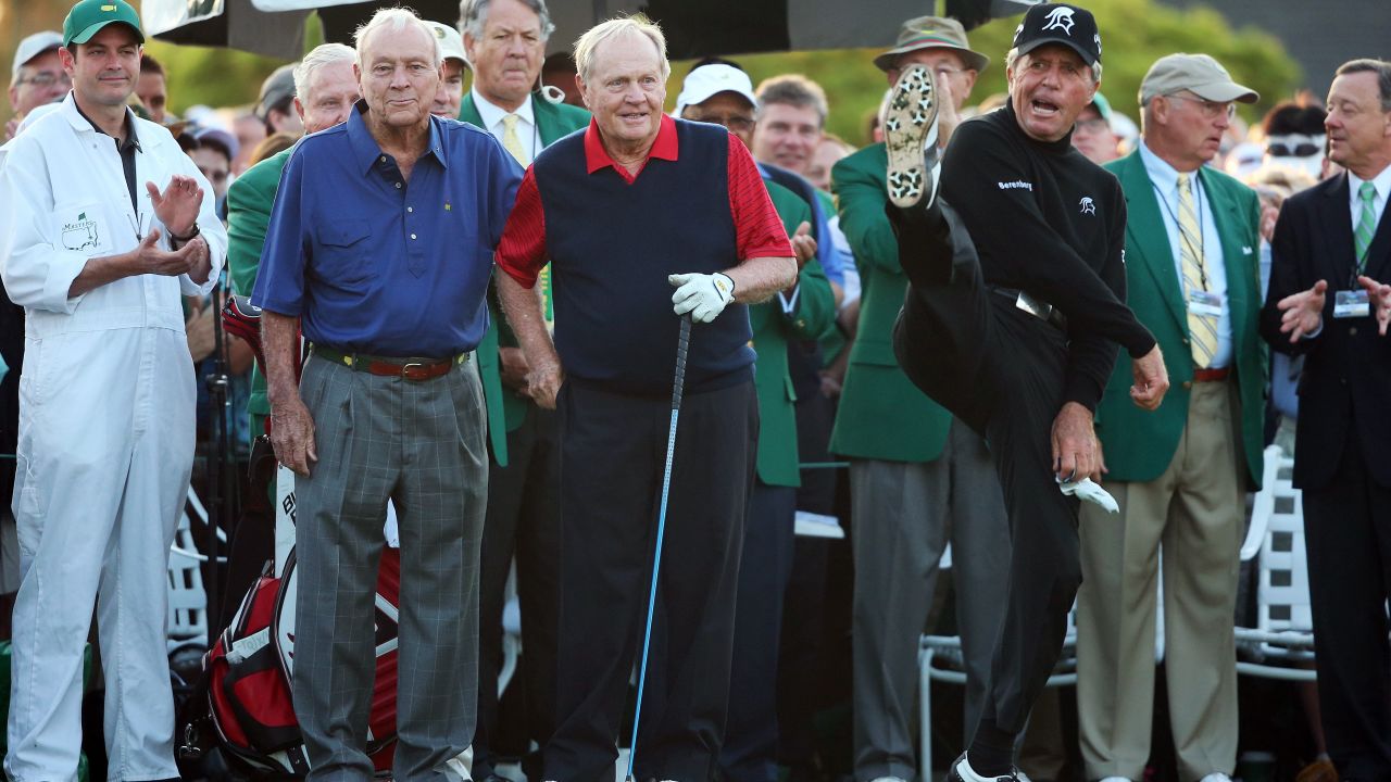 Player (right) demonstrates his agility with Arnold Palmer and Jack Nicklaus at Augusta in 2015