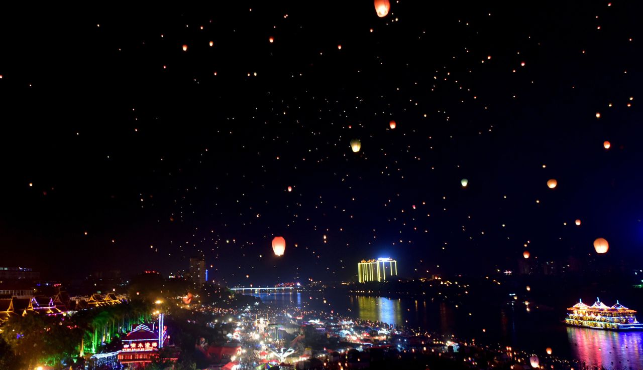 Dai people celebrate their new year by splashing water and releasing thousands of sky lanterns.