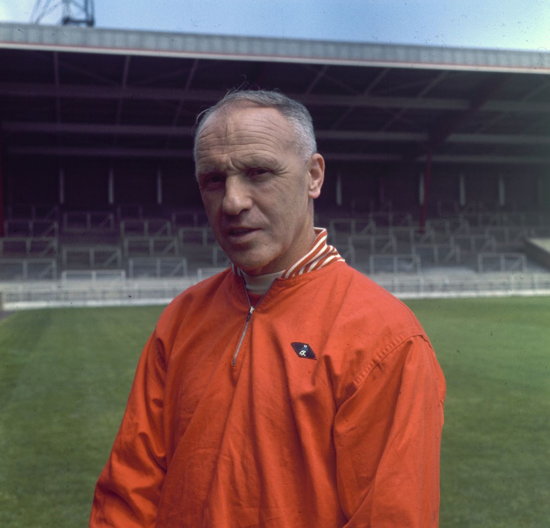 Former Liverpool manager Bill Shankly poses before the famous Spion Kop at Anfield.