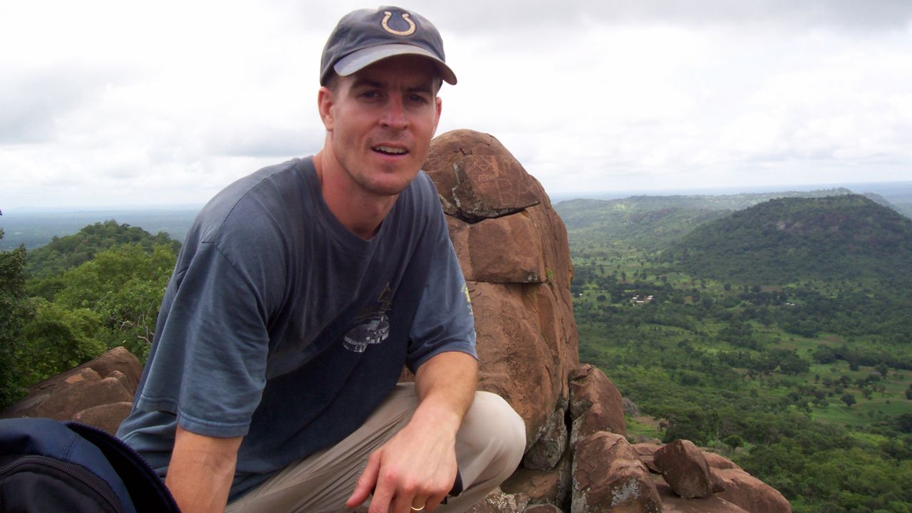 Microbiologist Brian Foy poses on a hillside above the villages of Ibel and Ndebou in southeastern Senegal in the summer of 2008. Senegal is a small country in West Africa.