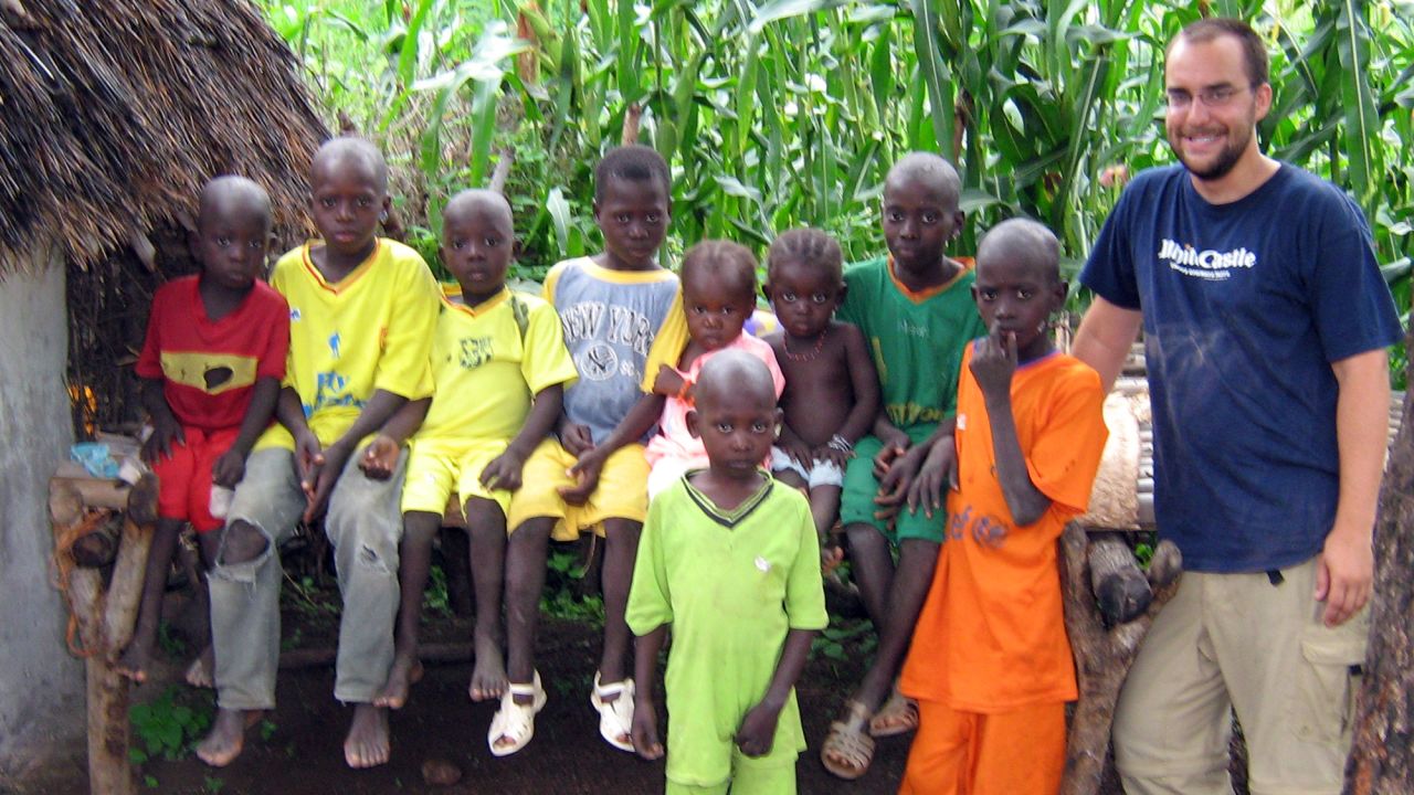 Kevin Kobylinski poses with village children. 