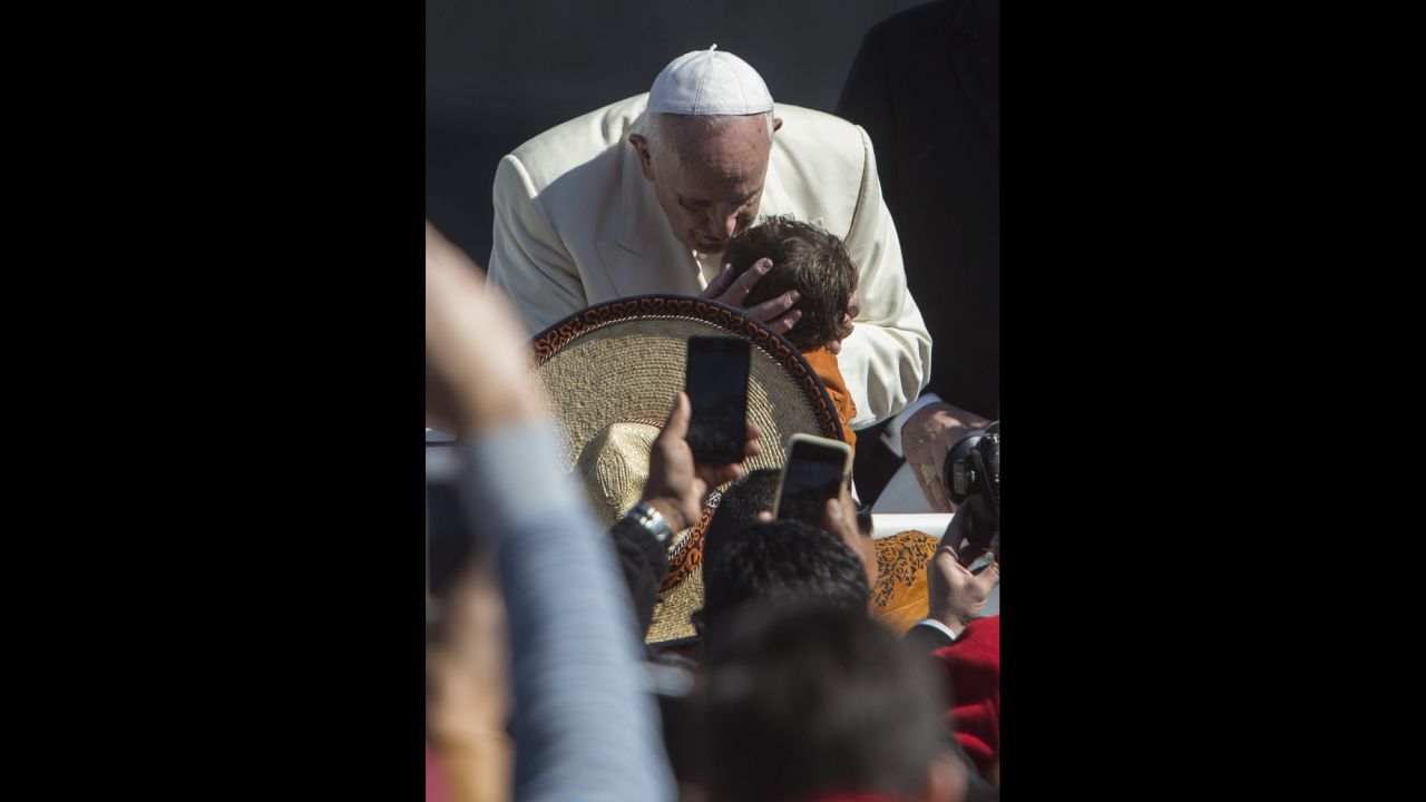 Pope Francis kisses a child in the Zocalo on February 13. 
