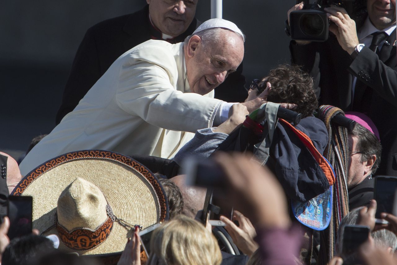 Pope Francis kisses a child in a wheelchair on February 13. 