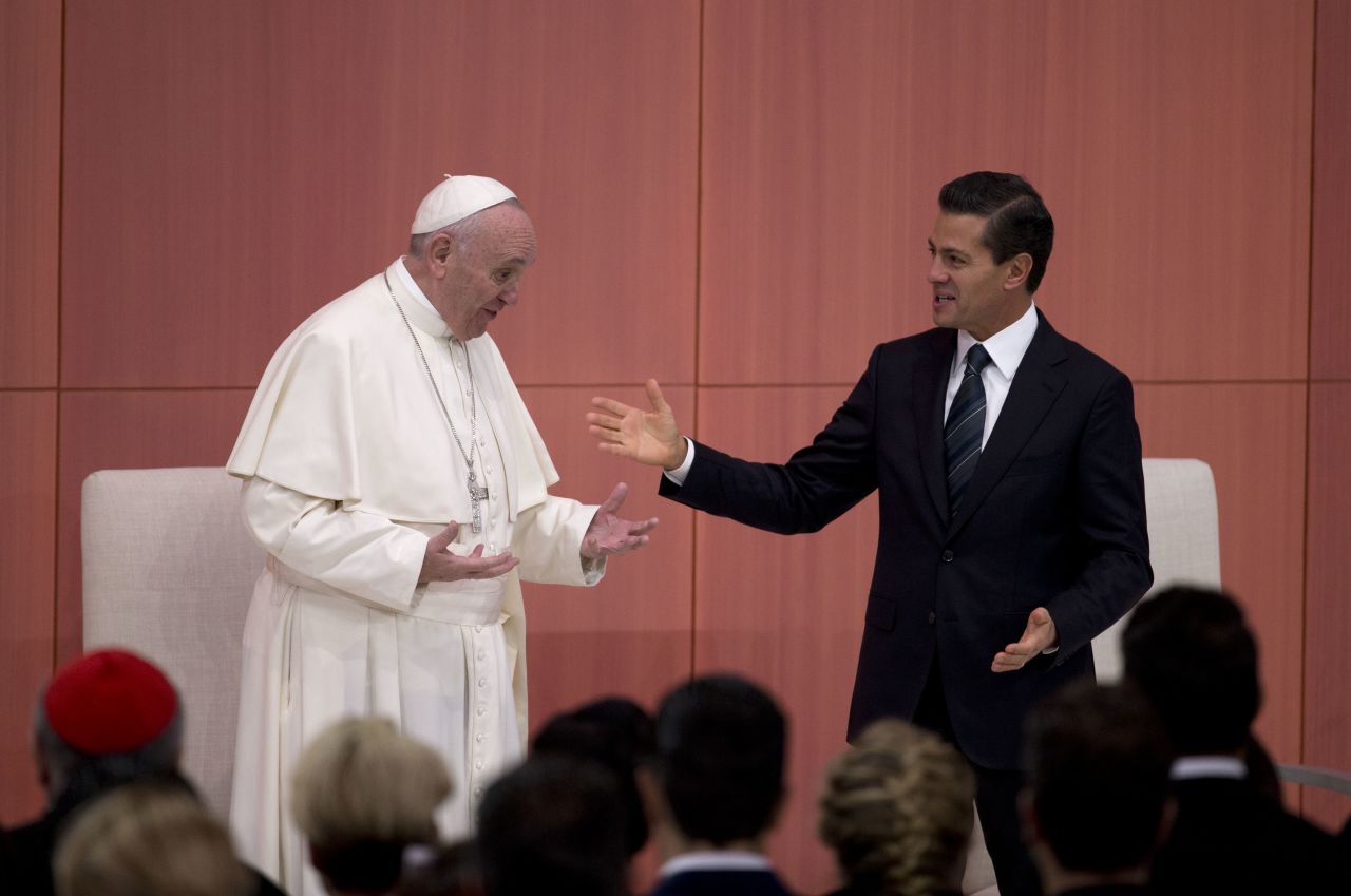 Pope Francis laughs with Mexican President Enrique Pena Nieto during a welcome ceremony at the National Palace.