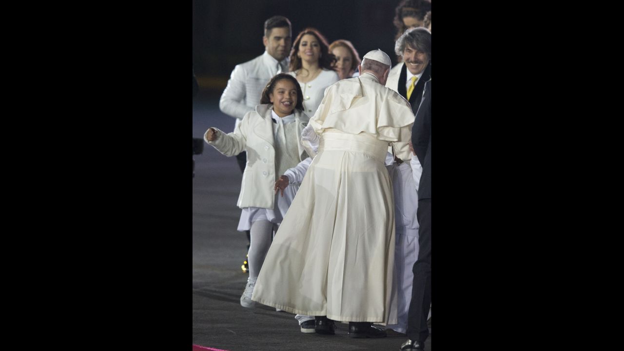 A group of children runs to embrace the Pope during his welcoming ceremony in Mexico City on February 12.