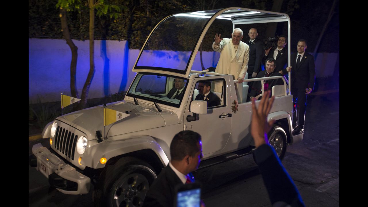 Pope Francis waves to people as he arrives to the Vatican's diplomatic mission in Mexico City on February 12.