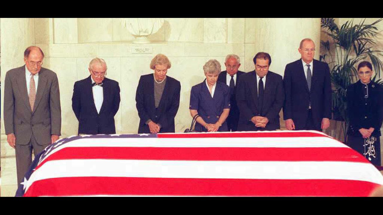 U.S. Supreme Court justices pay their respects in front of the casket of former Chief Justice Warren E. Burger during a prayer ceremony in the Great Hall at the Supreme Court Building in Washington on June 28, 1995.