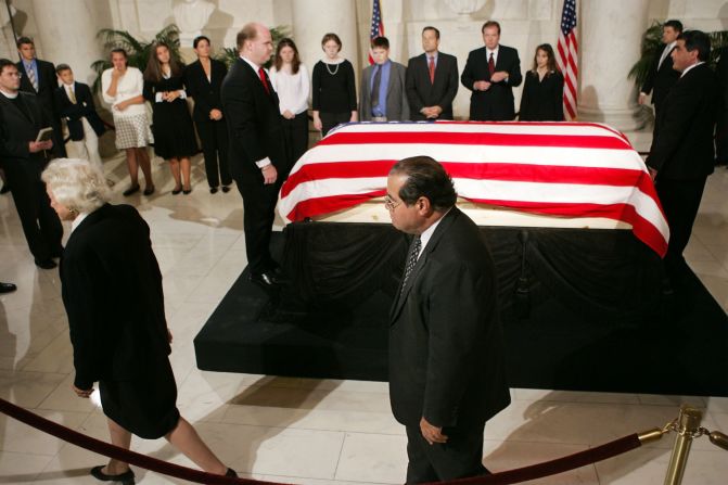 The casket of Chief Justice William H. Rehnquist lies in the Great Hall of the U.S. Supreme Court as Scalia and Sandra Day O'Connor, left, walk past on September 6, 2005, in Washington.