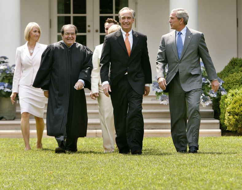 Heather Myklegard, Scalia, Dirk Kempthorne and U.S. President George W. Bush walk through the Rose Garden before Kempthorne is sworn in as the new interior secretary at White House on June 7, 2006, in Washington.