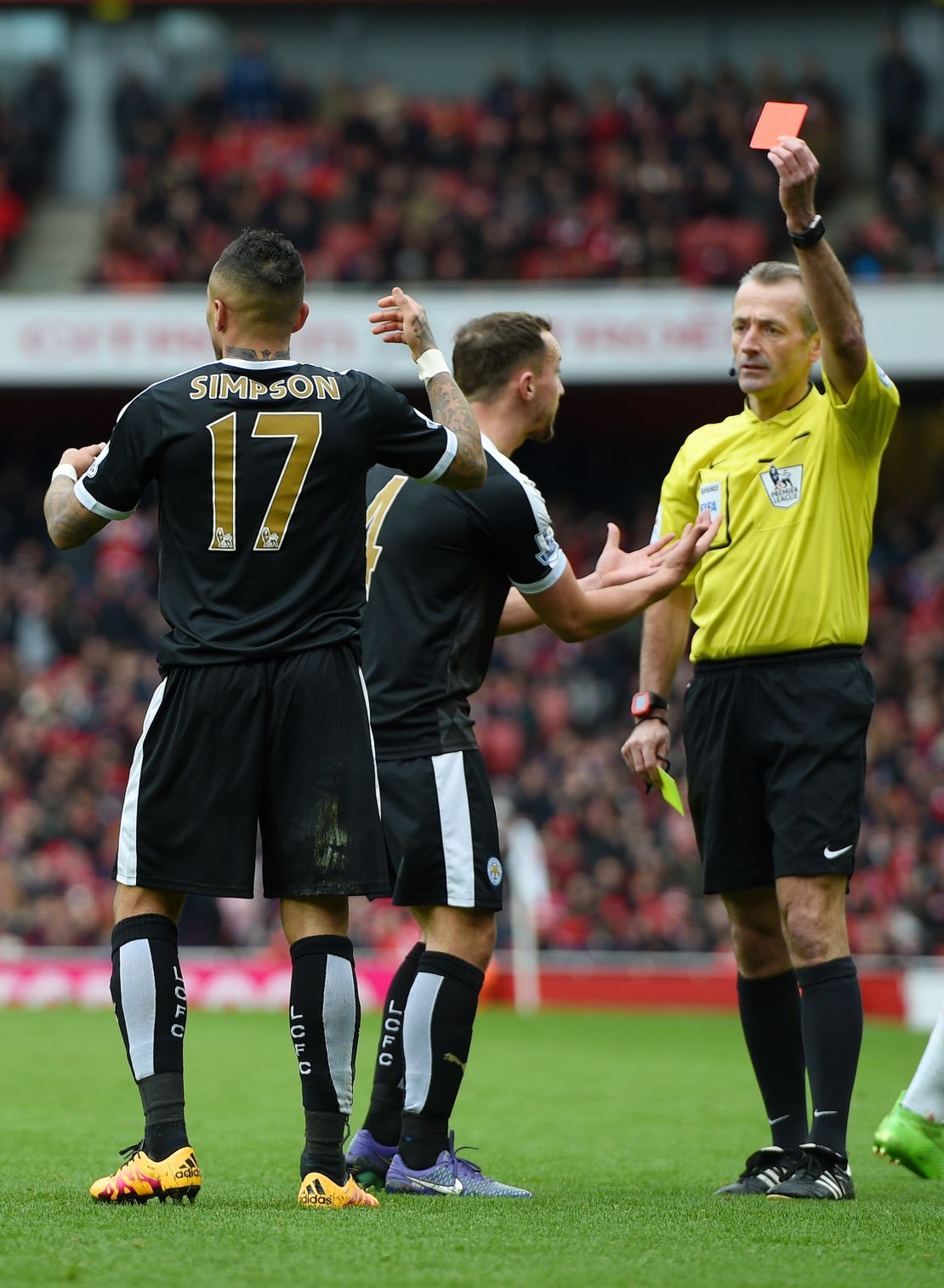 A pivotal moment in the title race? Referee Martin Atkinson shows a red card to Danny Simpson for a second yellow card foul.