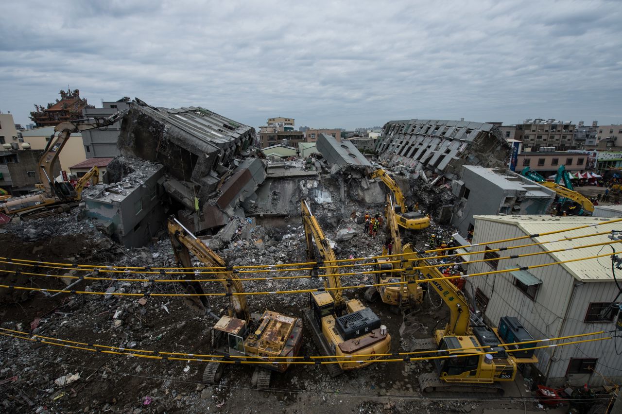 Rescue workers and excavation vehicles carry out their rescue and search operation on what was the top of the Weiguan apartment highrise which collapsed in the 6.4-magnitude earthquake in Taiwan on Friday, February 10, 2016.