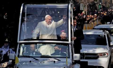 Pope Francis waves from his "Popemobile" on his way to take a helicopter to Ecatepec.