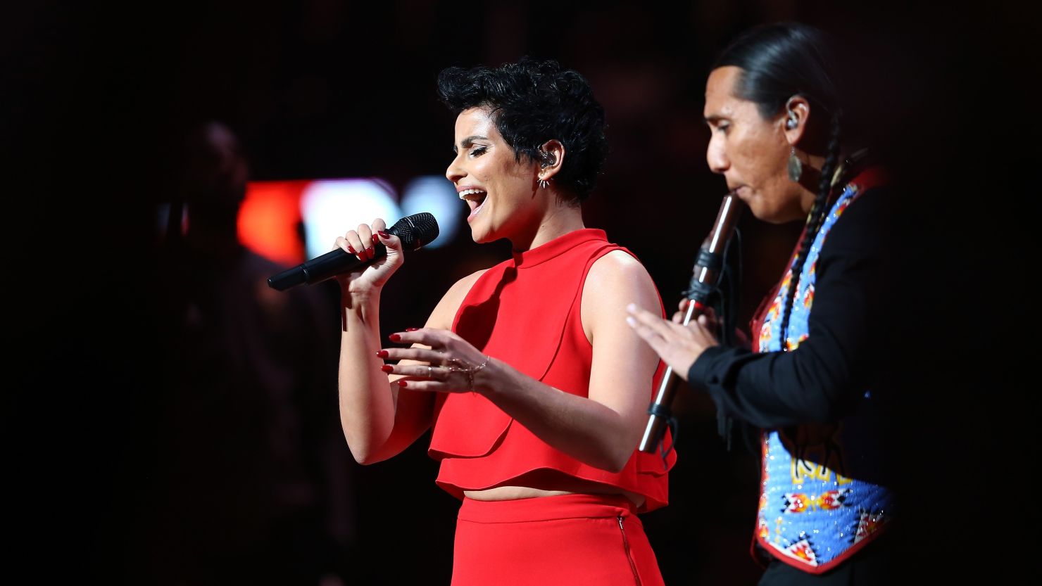 Singer Nelly Furtado performs the Canadian national anthem with flute player Tony Duncan at the NBA All-Star Game on Sunday. 
