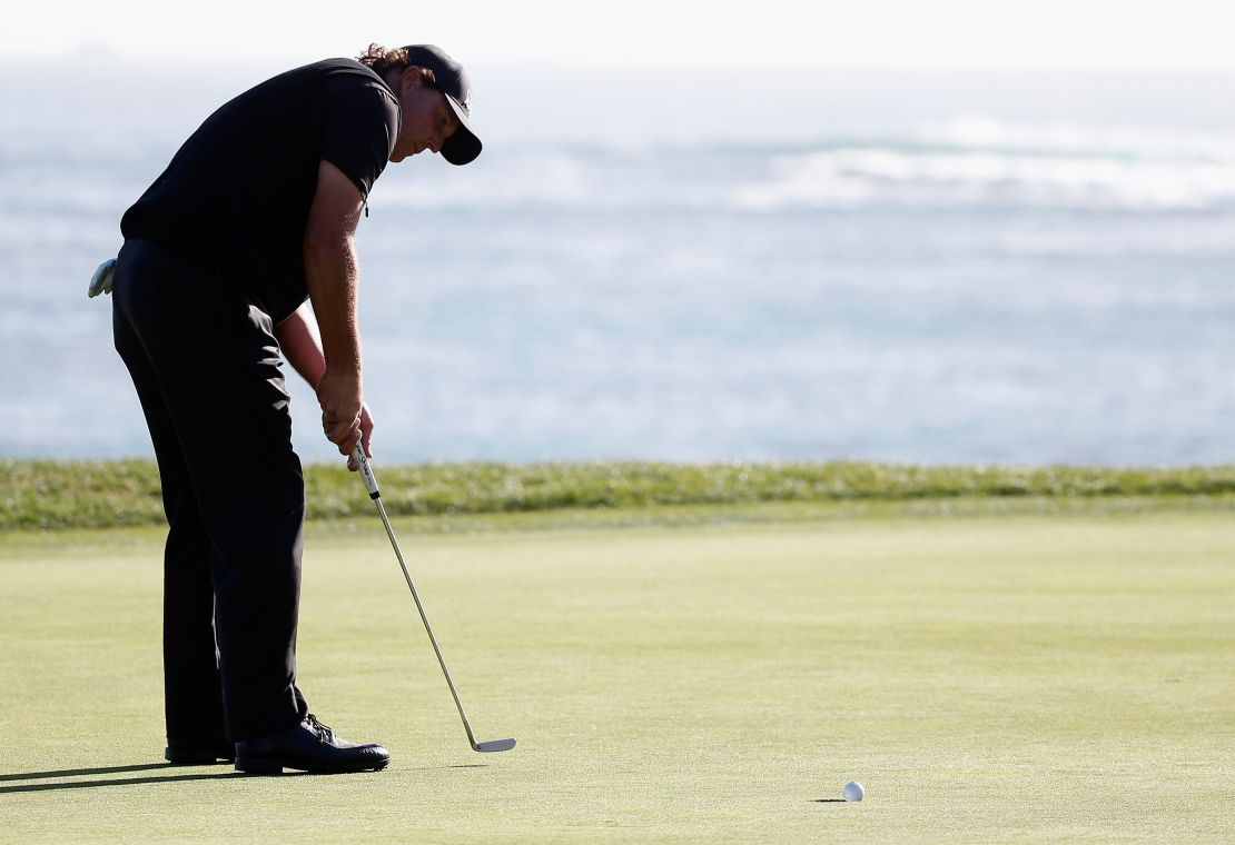 Mickelson watches on as his crucial putt rolls past the hole.