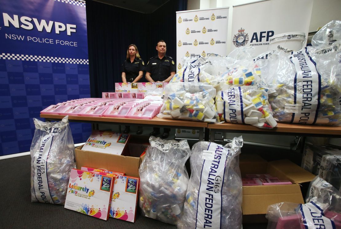 Officers stand by a display of confiscated drugs in Sydney.