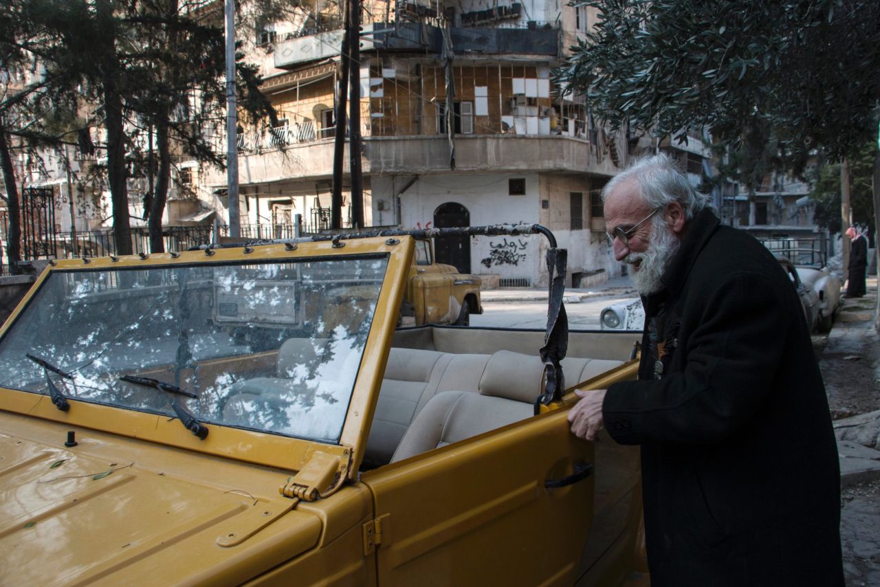 Omar inspects one of his cars in the al-Shaar district of Aleppo.