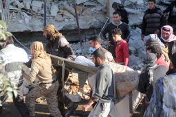 A victim is carried on a stretcher after the strike on the hospital in Maarat al-Numan, Idlib province.