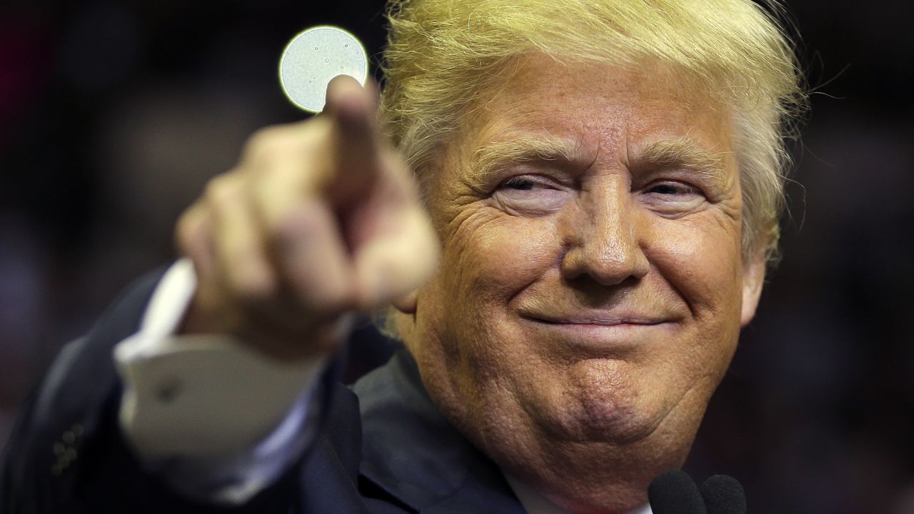 Republican presidential candidate Donald Trump points at a supporter during a rally Friday, Feb. 12, 2016, in Tampa, Fla. (AP Photo/Chris O'Meara)