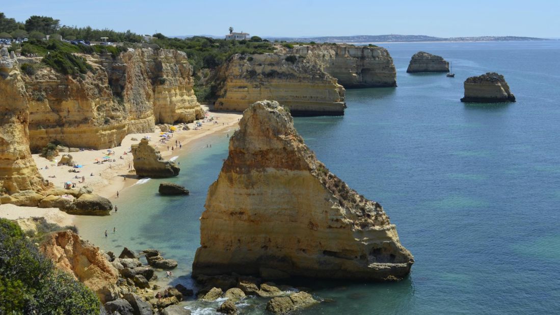 Stunning rock formations dot the shoreline at Praia da Marinha in Carvoeiro, Portugal.