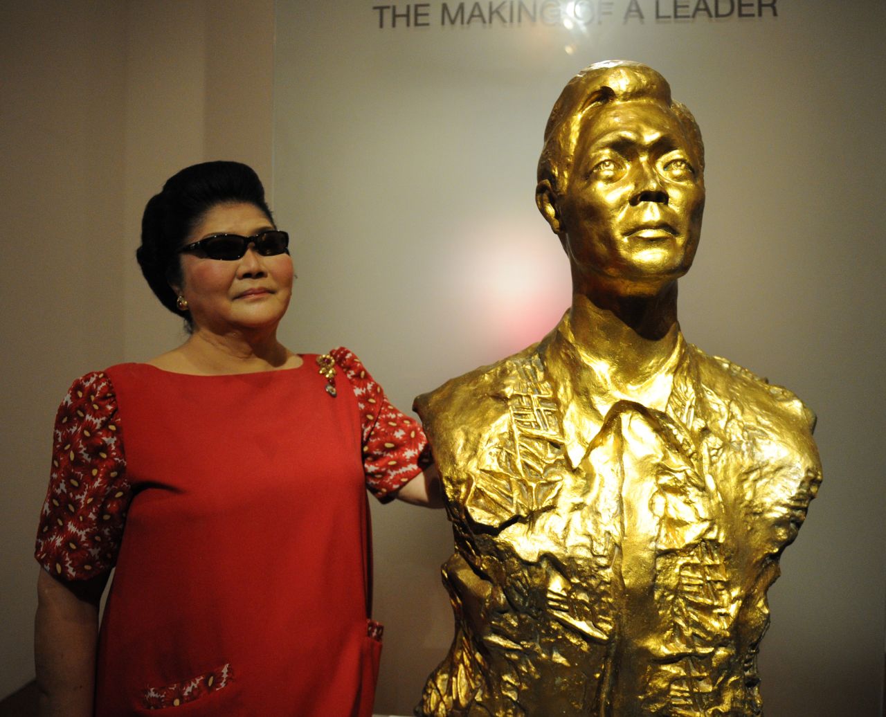 Former first lady Imelda Marcos stands next to a bust of her late husband and Philippine president, Ferdinand Marcos.