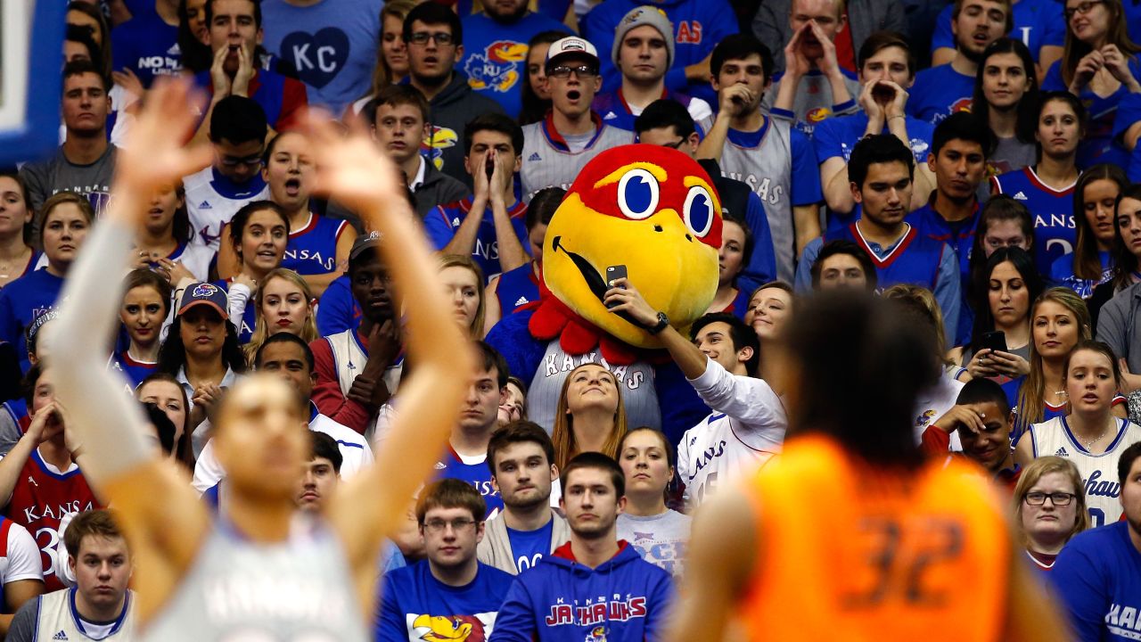 A Kansas basketball fan takes a selfie with the university's mascot, Big Jay, during a home game on Monday, February 15.